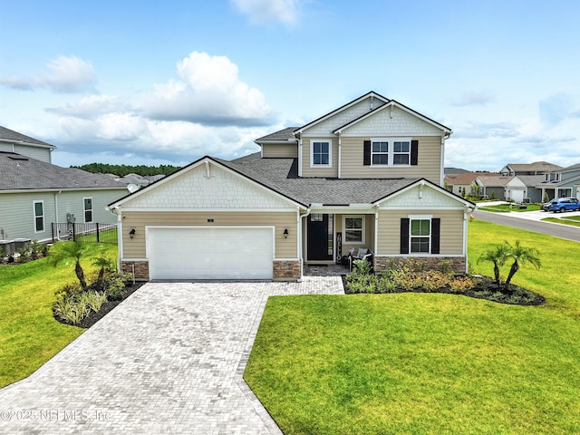 24 Tradesman Ln, Saint Johns, FL 32259 - craftsman inspired home featuring a garage, driveway, stone siding, covered porch, and a residential view
