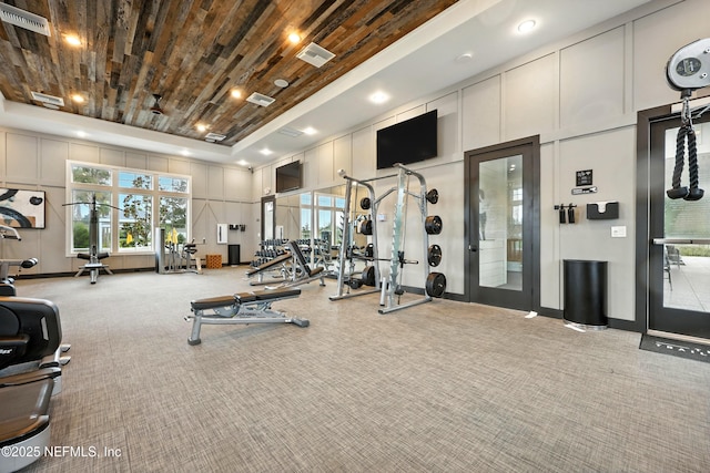 24 Tradesman Ln, Saint Johns, FL 32259 - exercise room featuring carpet floors, a decorative wall, a towering ceiling, and healthy amount of natural light