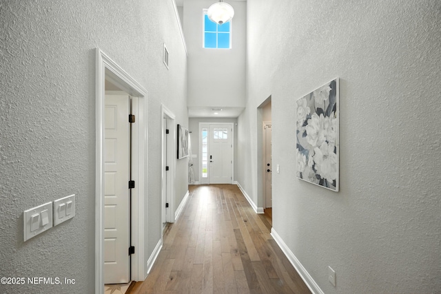 24 Tradesman Ln, Saint Johns, FL 32259 - hall with wood-type flooring, a textured wall, and a high ceiling