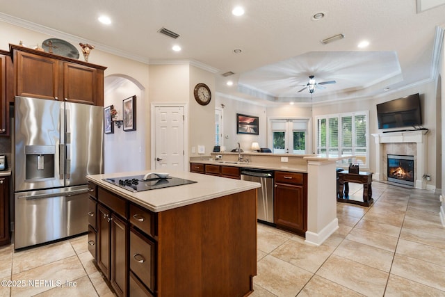 2025 Castle Point Ct, Fleming Island, FL 32003 - kitchen with stainless steel appliances, open floor plan, arched walkways, a ceiling fan, and light countertops
