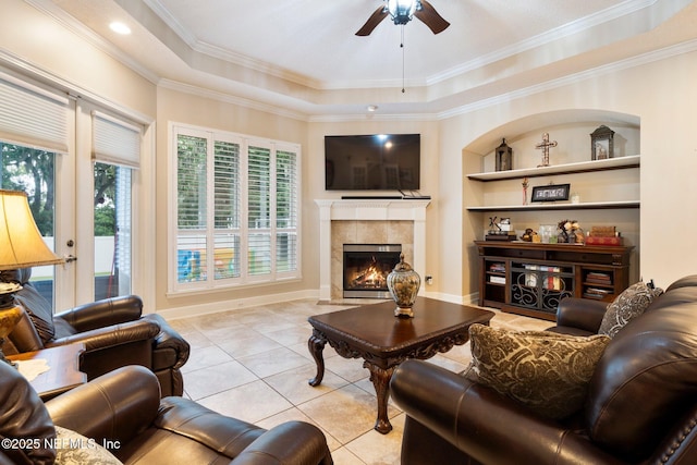 2025 Castle Point Ct, Fleming Island, FL 32003 - living room with plenty of natural light, ceiling fan, a high end fireplace, light tile patterned flooring, and crown molding