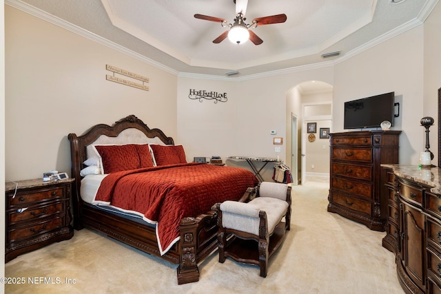 2025 Castle Point Ct, Fleming Island, FL 32003 - bedroom featuring arched walkways, light carpet, a raised ceiling, crown molding, and ceiling fan