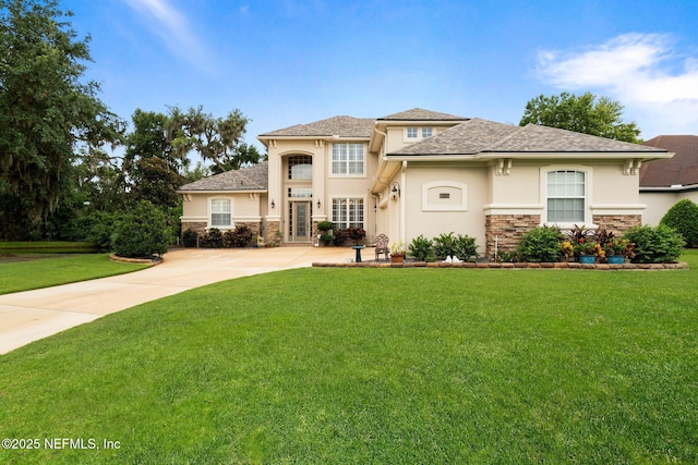 2025 Castle Point Ct, Fleming Island, FL 32003 - view of front facade featuring stone siding, stucco siding, and a front yard