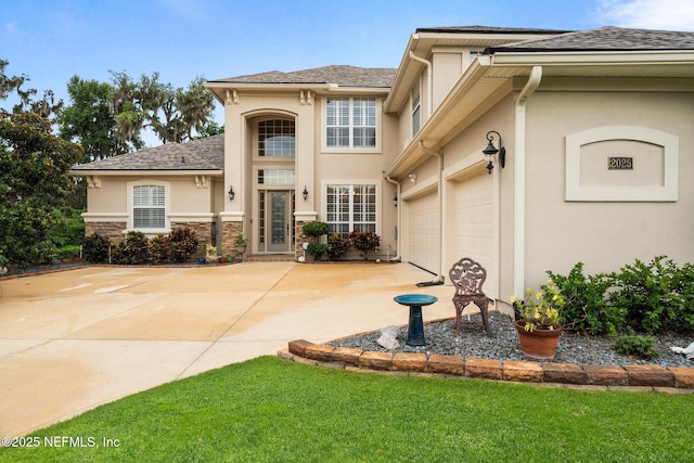 2025 Castle Point Ct, Fleming Island, FL 32003 - view of front facade featuring stucco siding, a garage, driveway, and a front yard