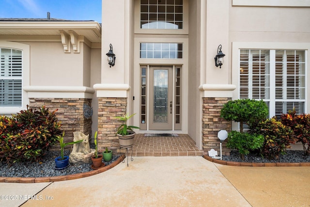 2025 Castle Point Ct, Fleming Island, FL 32003 - doorway to property with stucco siding and stone siding