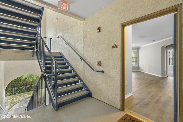 12700 Bartram Park Blvd Unit 1923, Jacksonville, FL 32258 - stairway featuring arched walkways, a textured wall, ornamental molding, and wood finished floors