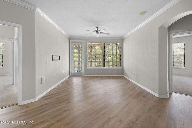 12700 Bartram Park Blvd Unit 1923, Jacksonville, FL 32258 - empty room with arched walkways, ceiling fan, healthy amount of natural light, ornamental molding, and wood finished floors
