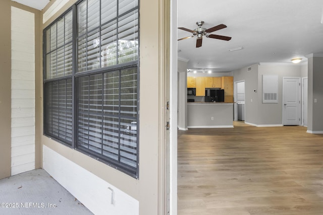 12700 Bartram Park Blvd Unit 1923, Jacksonville, FL 32258 - detailed view of black appliances, ornamental molding, ceiling fan, and wood finished floors