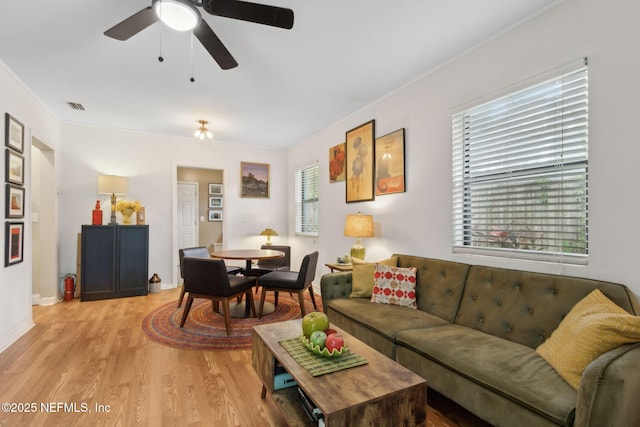 3207 Plum St, Jacksonville, FL 32205 - living area featuring light wood-type flooring, crown molding, and ceiling fan
