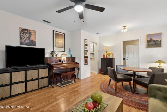 3207 Plum St, Jacksonville, FL 32205 - living room with wood finished floors, a ceiling fan, and crown molding