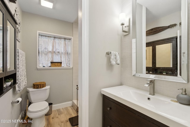 3207 Plum St, Jacksonville, FL 32205 - bathroom with vanity, backsplash, and wood finished floors