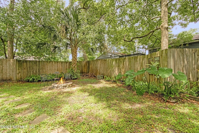 3207 Plum St, Jacksonville, FL 32205 - fenced backyard featuring a fire pit