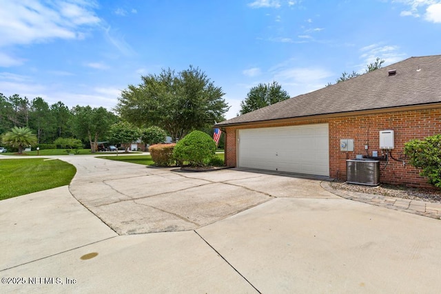 44677 Green Meadows Ln, Callahan, FL 32011 - view of home's exterior featuring concrete driveway, brick siding, an attached garage, and roof with shingles