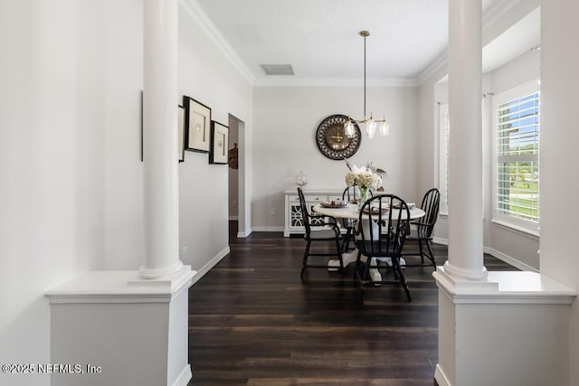 44677 Green Meadows Ln, Callahan, FL 32011 - dining area featuring dark wood finished floors, ornamental molding, decorative columns, and a chandelier