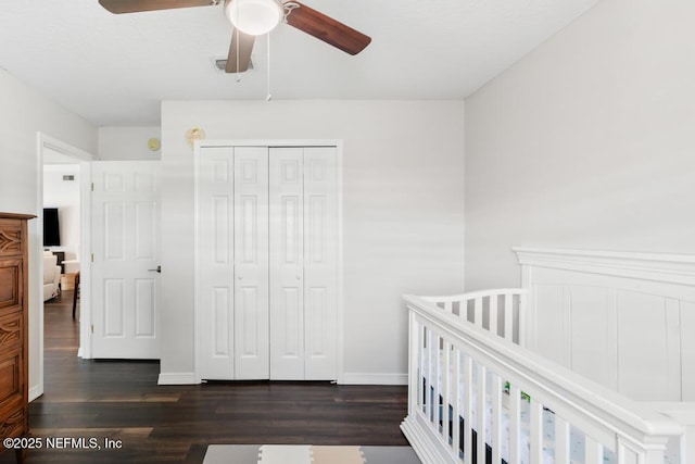44677 Green Meadows Ln, Callahan, FL 32011 - bedroom with dark wood-style floors, a closet, a nursery area, and a ceiling fan