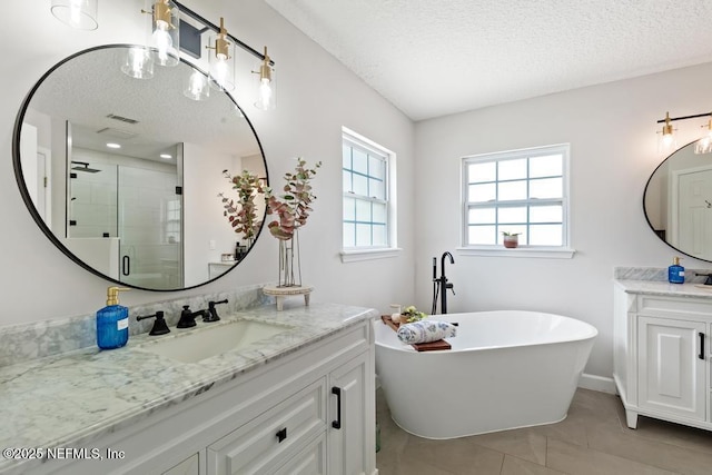 44677 Green Meadows Ln, Callahan, FL 32011 - full bath featuring a textured ceiling, two vanities, a shower stall, a freestanding tub, and tile patterned flooring