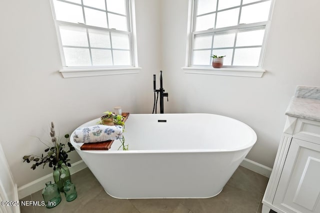 44677 Green Meadows Ln, Callahan, FL 32011 - full bathroom featuring healthy amount of natural light, a freestanding bath, and vanity