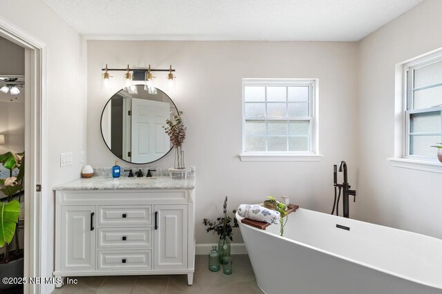 44677 Green Meadows Ln, Callahan, FL 32011 - full bath with vanity, a freestanding bath, and tile patterned flooring