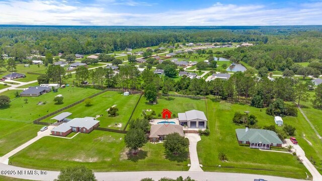 44677 Green Meadows Ln, Callahan, FL 32011 - aerial perspective of suburban area with a heavily wooded area