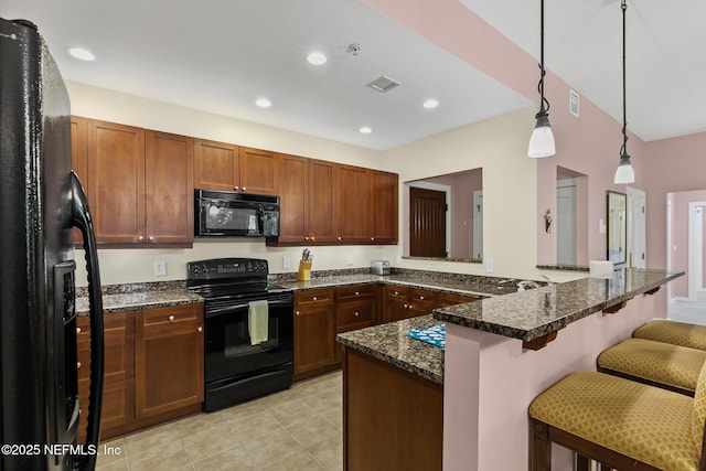 945 Registry Blvd Unit 312, Saint Augustine, FL 32092 - kitchen with black appliances, a kitchen breakfast bar, decorative light fixtures, a peninsula, and light tile patterned flooring