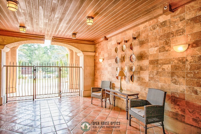 945 Registry Blvd Unit 312, Saint Augustine, FL 32092 - sitting room featuring wood ceiling, tile patterned flooring, crown molding, and decorative columns