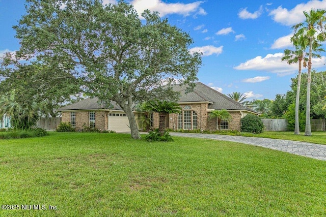 508 Lighthouse Ct, Neptune Beach, FL 32266 - view of front of house featuring driveway, an attached garage, and brick siding