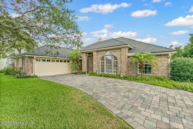 508 Lighthouse Ct, Neptune Beach, FL 32266 - ranch-style home featuring brick siding, a front lawn, a garage, and decorative driveway