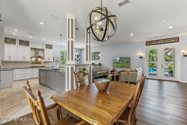 508 Lighthouse Ct, Neptune Beach, FL 32266 - dining space featuring a chandelier, light wood-style floors, recessed lighting, and a textured ceiling