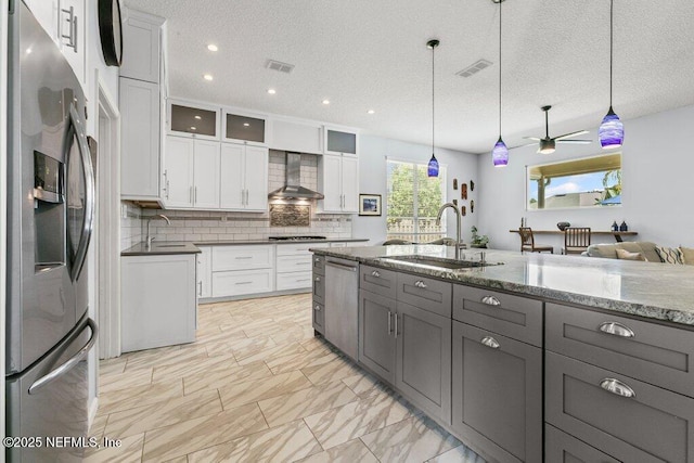 508 Lighthouse Ct, Neptune Beach, FL 32266 - kitchen featuring appliances with stainless steel finishes, wall chimney exhaust hood, gray cabinetry, tasteful backsplash, and ceiling fan