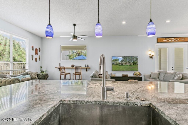 508 Lighthouse Ct, Neptune Beach, FL 32266 - kitchen with open floor plan, ceiling fan, hanging light fixtures, a textured ceiling, and recessed lighting