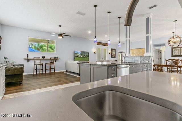 508 Lighthouse Ct, Neptune Beach, FL 32266 - kitchen featuring stainless steel dishwasher, wood finished floors, open floor plan, and a ceiling fan