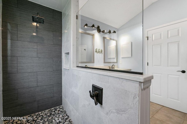 508 Lighthouse Ct, Neptune Beach, FL 32266 - bathroom with a walk in shower, lofted ceiling, tile patterned floors, and tile walls