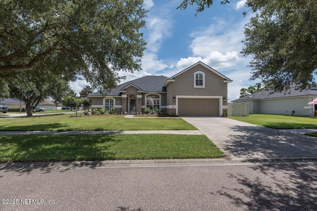 2484 Royal Pointe Dr, Green Cove Springs, FL 32043 - traditional-style home with an attached garage, driveway, a front yard, and stucco siding