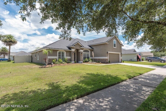 2484 Royal Pointe Dr, Green Cove Springs, FL 32043 - ranch-style home with concrete driveway, stone siding, a garage, and stucco siding
