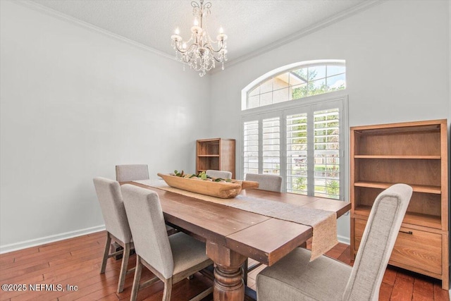 2484 Royal Pointe Dr, Green Cove Springs, FL 32043 - dining area featuring a chandelier, wood-type flooring, ornamental molding, and a textured ceiling