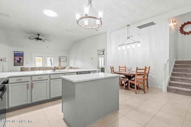 2484 Royal Pointe Dr, Green Cove Springs, FL 32043 - kitchen featuring gray cabinets, light tile patterned floors, open floor plan, light countertops, and a kitchen island