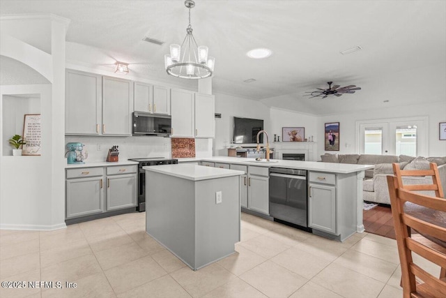 2484 Royal Pointe Dr, Green Cove Springs, FL 32043 - kitchen with appliances with stainless steel finishes, gray cabinetry, a peninsula, light countertops, and vaulted ceiling