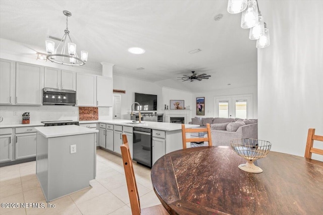 2484 Royal Pointe Dr, Green Cove Springs, FL 32043 - kitchen with stainless steel microwave, black dishwasher, a peninsula, and light tile patterned floors