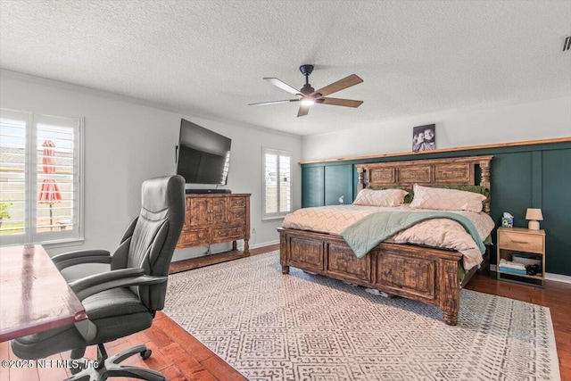 2484 Royal Pointe Dr, Green Cove Springs, FL 32043 - bedroom featuring wood finished floors, a desk, a ceiling fan, and a textured ceiling