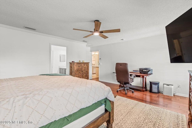 2484 Royal Pointe Dr, Green Cove Springs, FL 32043 - bedroom with wood finished floors, connected bathroom, ornamental molding, a textured ceiling, and ceiling fan