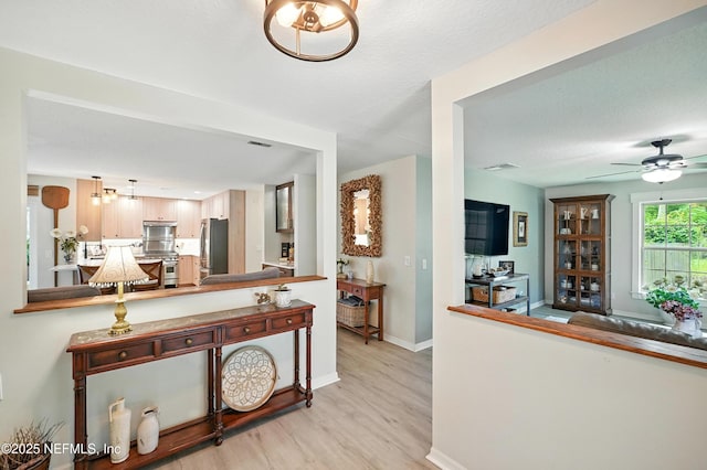 603 Miramar Ct, Ponte Vedra Beach, FL 32082 - kitchen with light wood-style floors, stainless steel appliances, ceiling fan, and a peninsula