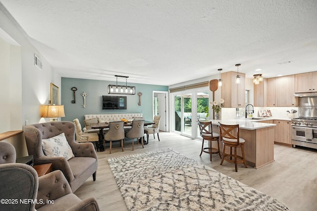 603 Miramar Ct, Ponte Vedra Beach, FL 32082 - living room with light wood-style flooring and a textured ceiling