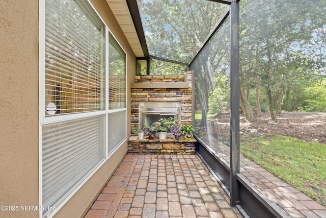 2269 Cascadia Ct, Saint Augustine, FL 32092 - unfurnished sunroom with a stone fireplace