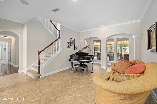 2269 Cascadia Ct, Saint Augustine, FL 32092 - living room with decorative columns, arched walkways, ornamental molding, stairway, and light tile patterned flooring