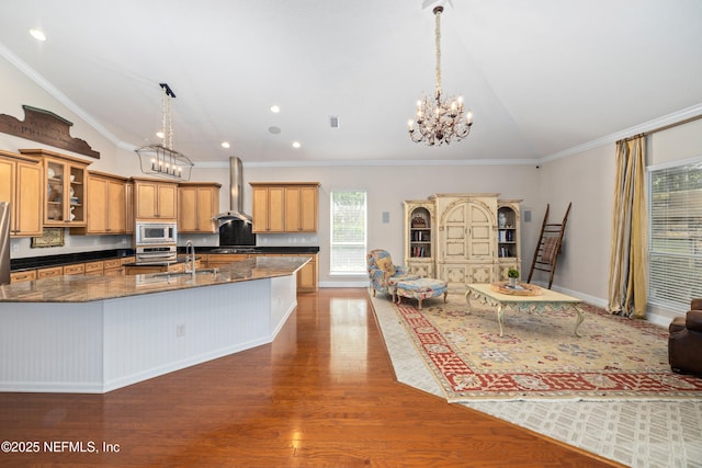 2269 Cascadia Ct, Saint Augustine, FL 32092 - kitchen featuring built in microwave, wall chimney exhaust hood, lofted ceiling, a chandelier, and dark wood finished floors