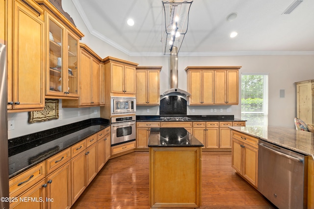 2269 Cascadia Ct, Saint Augustine, FL 32092 - kitchen with appliances with stainless steel finishes, dark wood-type flooring, a center island, wall chimney exhaust hood, and crown molding