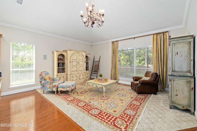 2269 Cascadia Ct, Saint Augustine, FL 32092 - living room with crown molding, light wood-style flooring, and a chandelier