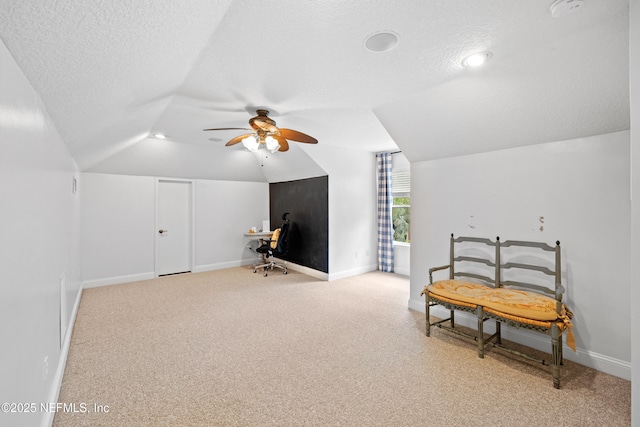 2269 Cascadia Ct, Saint Augustine, FL 32092 - sitting room with vaulted ceiling, a ceiling fan, a textured ceiling, a desk, and carpet floors