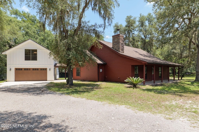2871 Anchor Rd, Middleburg, FL 32068 - view of front of home with gravel driveway, a chimney, a front lawn, and covered porch