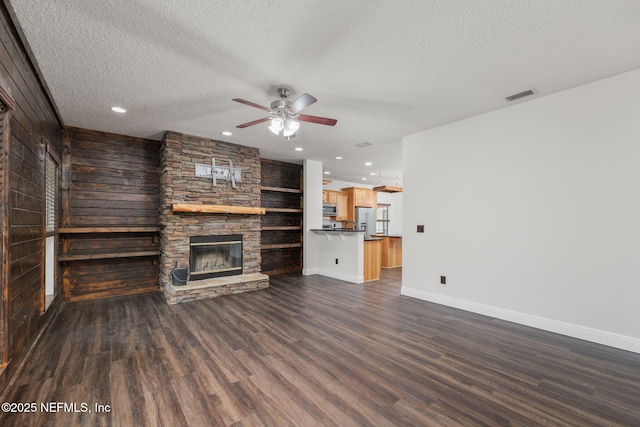 2871 Anchor Rd, Middleburg, FL 32068 - unfurnished living room featuring a ceiling fan, a fireplace, dark wood-style flooring, a textured ceiling, and recessed lighting